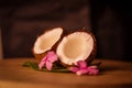 Grounded coconut flakes,half coconut with green leaves wooden on background,hd footage of coconut milk and half coconut on wooden Royalty Free Stock Photo