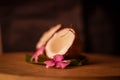 Grounded coconut flakes,half coconut with green leaves wooden on background,hd footage of coconut milk and half coconut on wooden Royalty Free Stock Photo