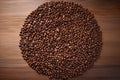 grounded coffee beans arranged in a spiral pattern on a wooden table Royalty Free Stock Photo