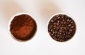 Grounded coffee and coffee beans in cups isolated on white