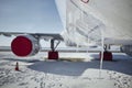 Grounded plane at snowy airport in frosty day