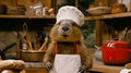 A groundhog wearing a chef's hat and white apron, AI