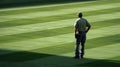 A grounds crew member surveys the field back to the camera as they make lastminute adjustments to the pristine playing Royalty Free Stock Photo