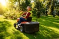 Groundskeeper maintaining lawn with motorized mower Royalty Free Stock Photo