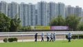 Groundskeepers work on the field inside a horse-track in Hong Kong