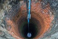 Groundwater well with water in the bottom Royalty Free Stock Photo