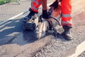 Groundworker cutting road with petrol saw Royalty Free Stock Photo