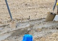 Groundworker placing wet concrete into formwork on building site Royalty Free Stock Photo
