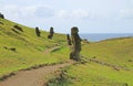 Group of abandoned massive Moai statues scattered on the slope of Rano Raraku volcano, historic Moai quarry on Easter Island