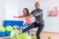 Group of active cheerful sporty women doing single leg squats with balance ball training indoors in gym Royalty Free Stock Photo