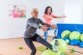 Group of active cheerful sporty women doing single leg squats with balance ball training indoors in gym Royalty Free Stock Photo