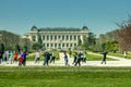 Group of active elderly people doing exercises in the park in spring in Paris