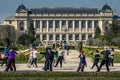 Group of active elderly people doing exercises in the park in spring in Paris