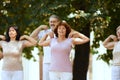 Group of active, elderly people, man and women training outdoors in park, doing warm-up exercises Royalty Free Stock Photo