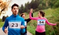 A group of multi generation people running a race competition in nature. Royalty Free Stock Photo