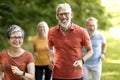 Group of active senior people running together outdoors in park Royalty Free Stock Photo