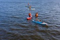 Group of active tourists stand up paddling on sup boards