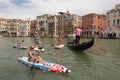 Group of active tourists stand up paddling on sup boards at Grand Canal, Venice, Italy.