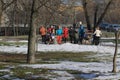 A group of active women in a city park performs light sports exercises.