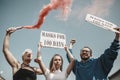 Group of activists protesting, supporting masks for 100 days in America. Look angry, hopeful, confident. Banners and