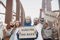 Group of activists protesting, supporting masks for 100 days in America. Look angry, hopeful, confident. Banners and