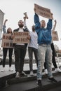 Group of activists protesting, supporting masks for 100 days in America. Look angry, hopeful, confident. Banners and