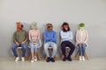 Group of adult people wearing funny animal masks waiting for job interview in office