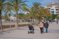 Group of adult persons with disabled man, senior on electric wheelchair