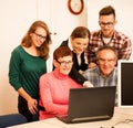 Group of adults learning computer skills. Intergenerational tran Royalty Free Stock Photo