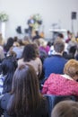 Group of Adults Listening to the Host on Stage