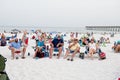 A group of adults sit in beach chairs on the sand at Pensacola. Beach, Florida