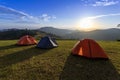 Group of adventurer tents during overnight camping site at the beautiful scenic sunset view point over layer of mountain for Royalty Free Stock Photo