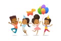 Group of African-American happy boys and girls with the balloons and birthday hats happily jumping with their hands up Royalty Free Stock Photo