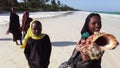 A group of African children extort money on a beach in Zanzibar, Africa.