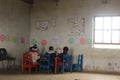 Group of african children studying by a desk in rural Swaziland