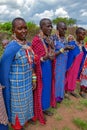 Group african women from Masai tribe in multi-colored cotton dresses and beaded jewelry
