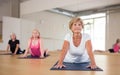 Group of aged ladies doing cobra pose