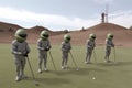 group of aliens enjoying a round of golf, with their clubs and balls visible