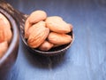 Group of almonds seeds in a wooden spoon