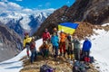 Group of alpinists in the high mountains with Ukrainian flag