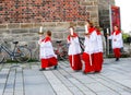 A group of Altar Boys leave church on catholic holiday Mary's Asumption