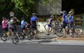 group of amateur cyclists refreshes in front of a public fountain