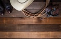 American Cowboy Items incluing a lasso spurs and a traditional straw hat on a wood plank background Royalty Free Stock Photo
