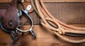 American Cowboy Items incluing a lasso spurs and a traditional straw hat on a wood plank background