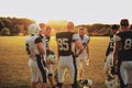 Football team talking during a late afternoon practice Royalty Free Stock Photo