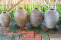 A group of ancient earthenware containers for placing water on brick floors, vintage tone images