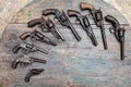 A group of ancient pistols on vintage wooden table