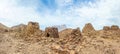 Group of ancient stone beehive tombs with Jebel Misht mountain in the background, archaeological site near al-Ayn, sultanate Oman