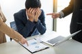 Group Of Angry Business people Blaming Male Colleague In Meeting