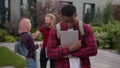 Group of angry students teenagers multiracial classmates laughing humiliate bully mockery at college university outdoors